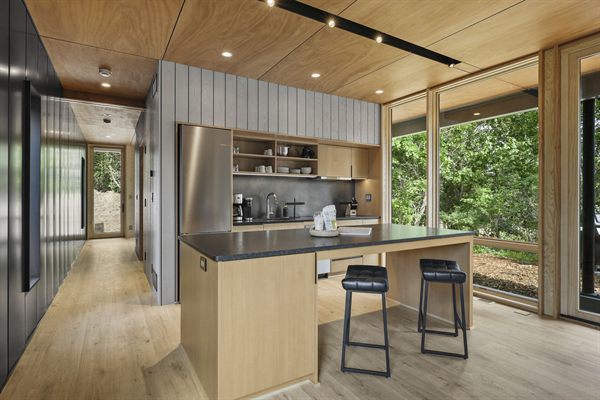 Oak and Ember cabin interior with warm finishes and wooded views