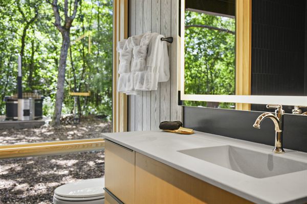 Oak and Ember cabin interior with warm finishes and wooded views