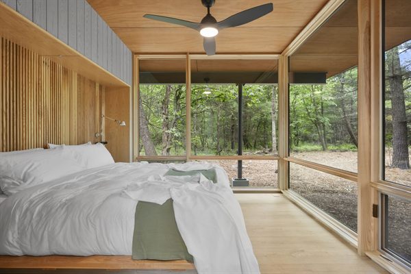 Oak and Ember cabin interior with warm finishes and wooded views