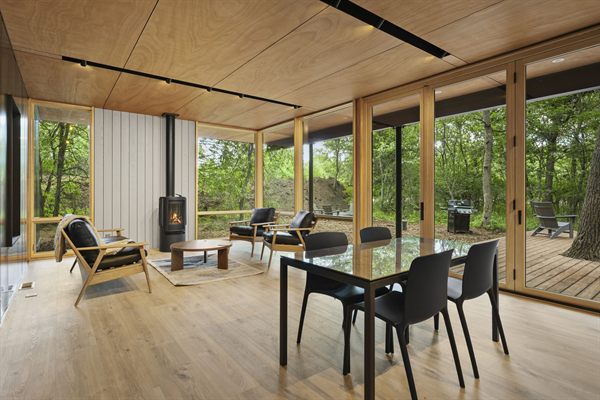 Oak and Ember cabin interior with warm finishes and wooded views