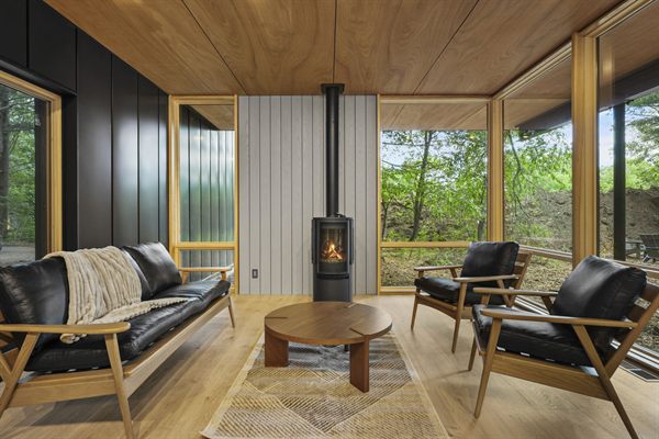 Oak and Ember cabin interior with warm finishes and wooded views