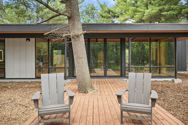 Oak and Ember modern cabin exterior and wooded outdoor space