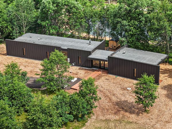 Aerial view of Oak and Ember cabins, pond, and wooded acreage