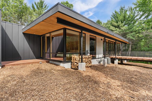 Oak and Ember modern cabin exterior and wooded outdoor space