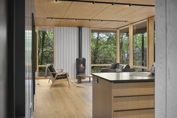 Oak and Ember cabin interior with warm finishes and wooded views