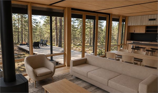 The Pines cozy Nordic-inspired living space with floor-to-ceiling windows