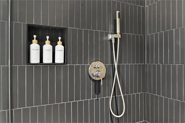 The Pines walk-in shower with dark tile