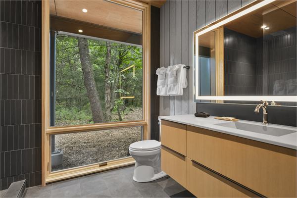 The Pines bathroom with modern vanity and wooded views