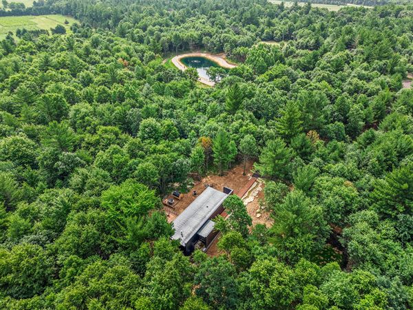 Aerial view of The Point cabin tucked into Oak and Ember wooded acreage