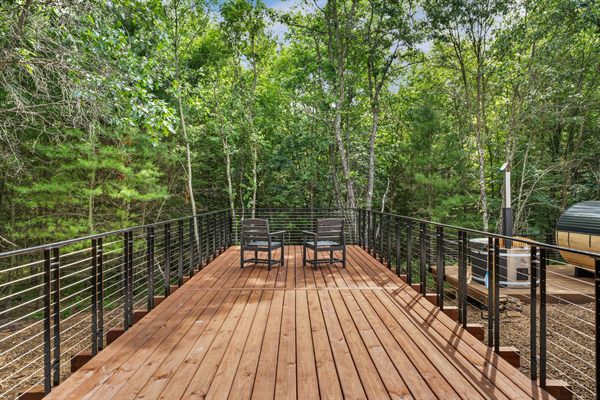 The Point private deck and outdoor gathering space in the woods
