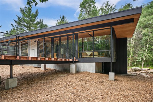 The Point modern cabin exterior surrounded by mature trees