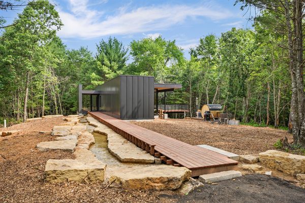 The Point modern cabin exterior surrounded by mature trees