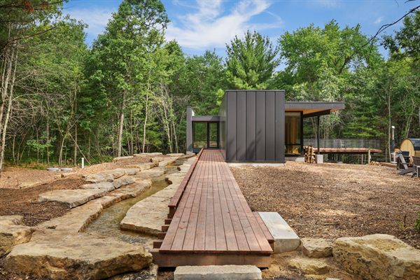 The Point modern cabin exterior surrounded by mature trees
