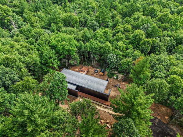 Aerial view of The Point cabin tucked into Oak and Ember wooded acreage