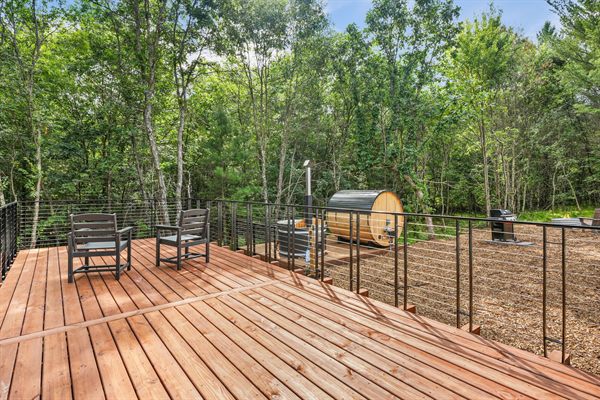 The Point modern cabin exterior surrounded by mature trees