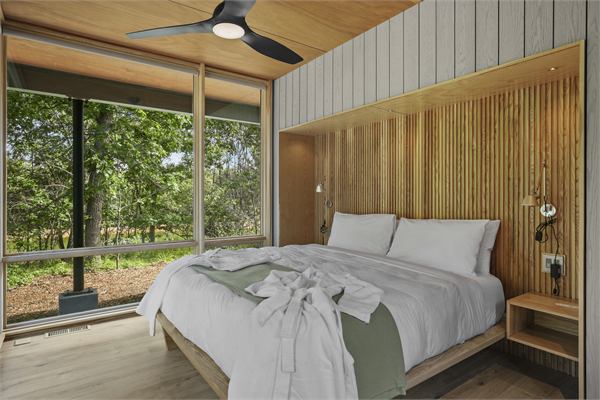 The Ridge king bedroom with corner windows and wooded views