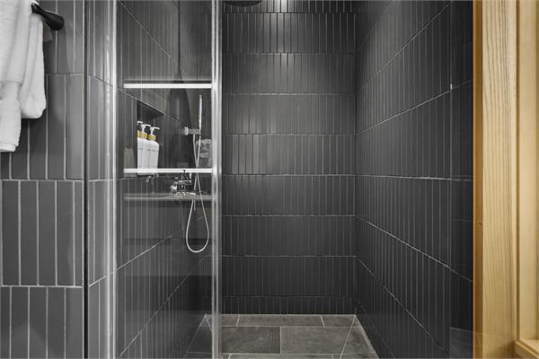 The Ridge walk-in shower with dark tile