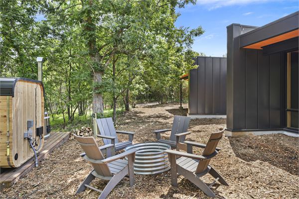 The Ridge exterior with modern glass and wooded views