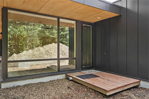 The Ridge exterior with modern glass and wooded views