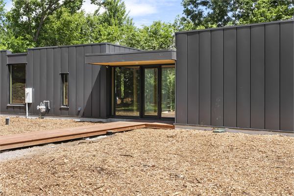 The Ridge exterior with modern glass and wooded views