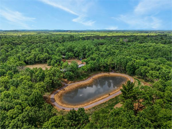 Aerial view of Oak and Ember private pond and wooded acreage near The Ridge